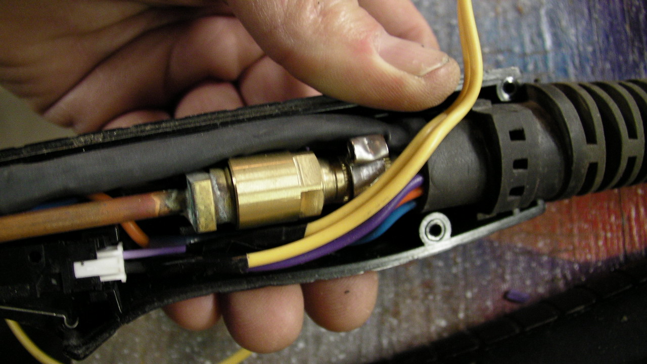 Notch the handle and route the wire out.