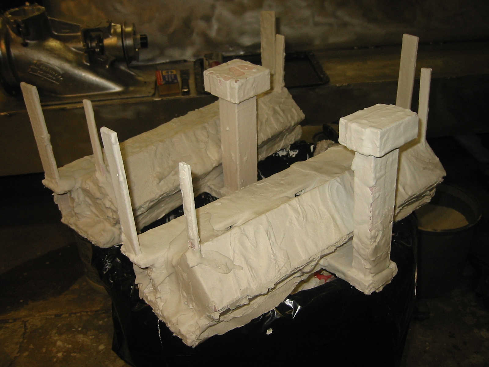 Plaster and silica investment applied to exhaust manifolds.