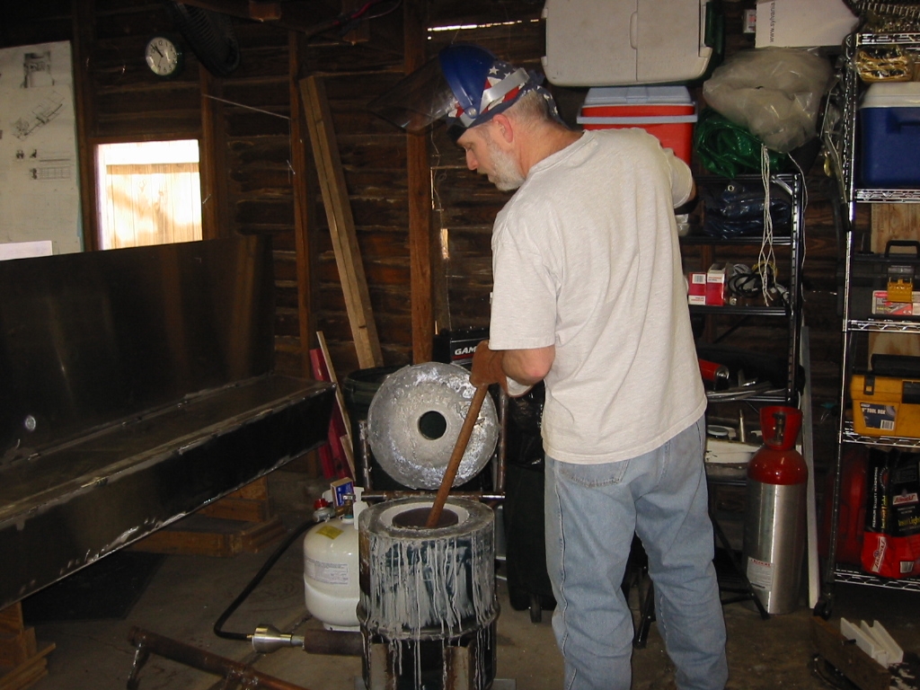 The skimmer is a pipe with a shorter piece of pipe welded to the end to from a Tee.
