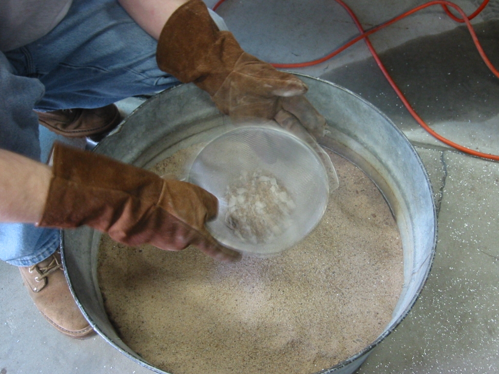 A sifter is used to clean the chips of mud out of the sand.