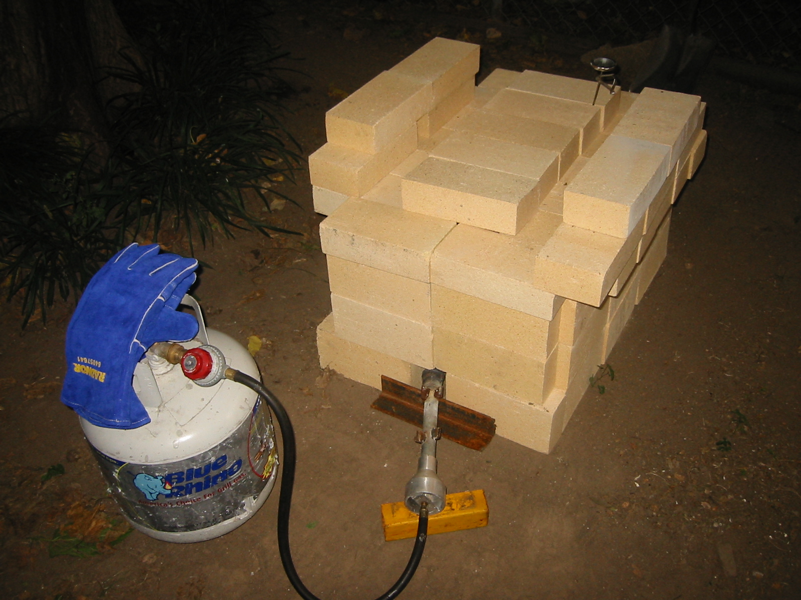 Firing investment in a temporary firebrick kiln.