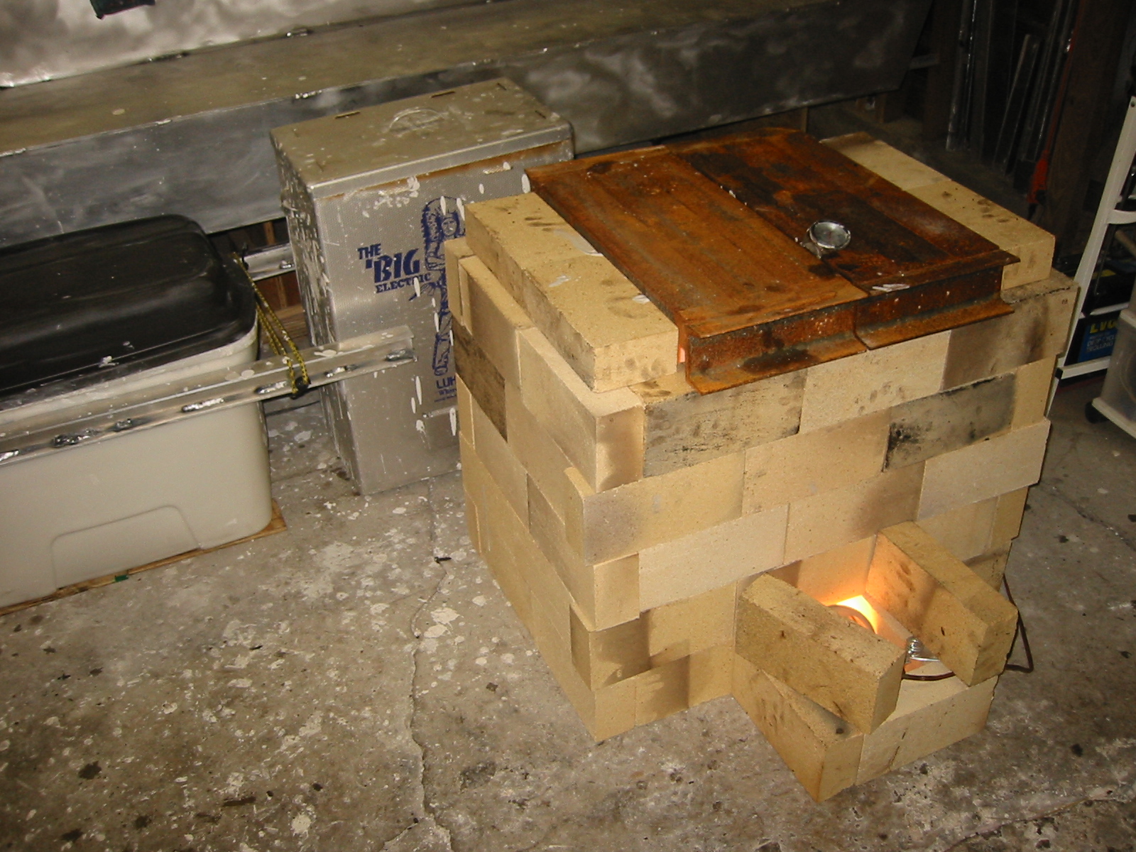 Storage container of mud, meat smoker for drying small parts and a firebrick kiln for bigger parts.