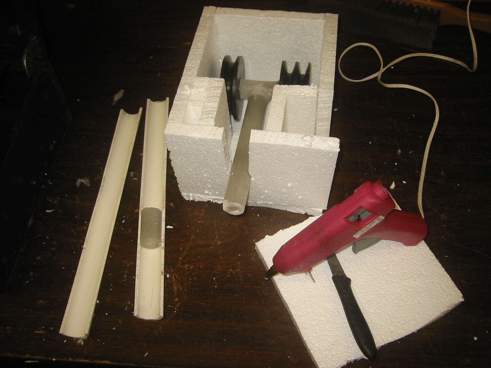 Making a split mold requires making a box around the part. Filling it half way up with plaster then adding a parting agent like petroleum jelly before filling the box on up with plaster.