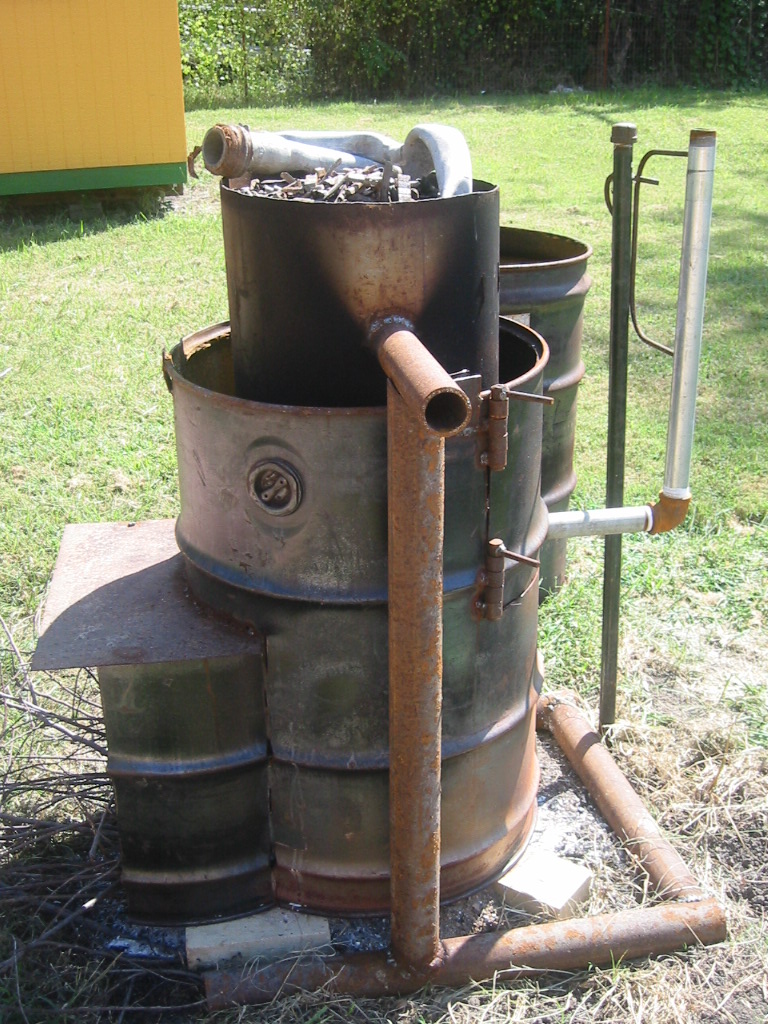 Melting pot is suspended in a 55 gallon drum and a pipe plumbed to the bottom can be tilted to pour the lead off.