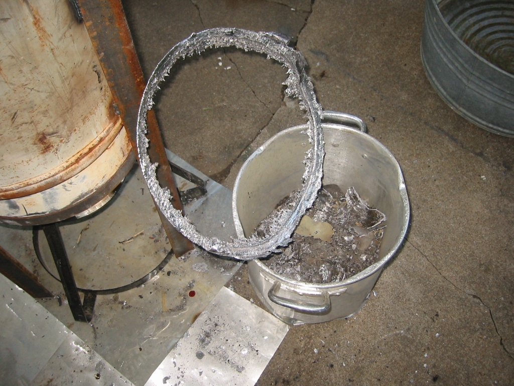 Lead pipe often has a fair amount of antimony mixed into the lead. The antimony will need more heat to melt and it will cool form a ring at the top of the pot.