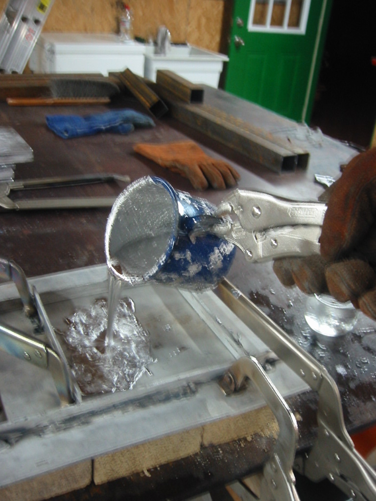 Pouring lead into the mold.