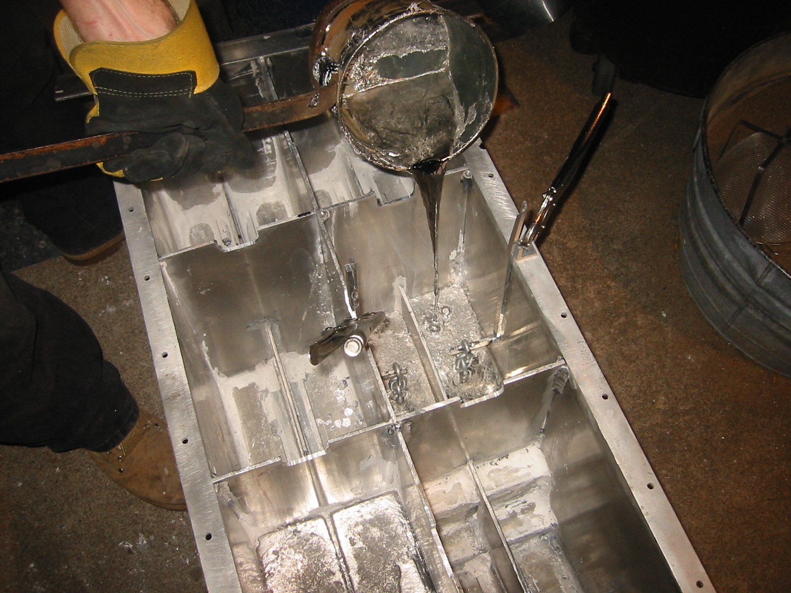 Pouring molten lead into the lower compartments of theballast sled.