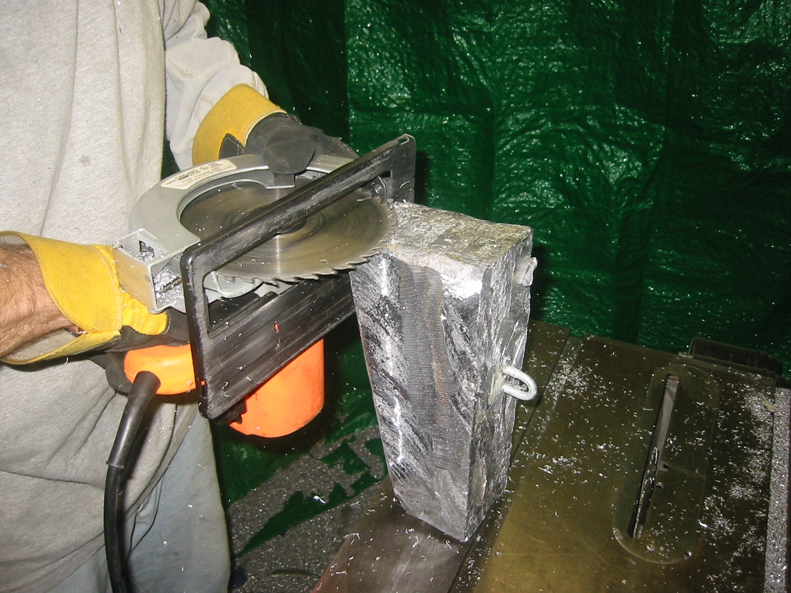 We trimmed the lead blocks with a skill saw using a carbide blade. Tarps were hung to catch the chips.