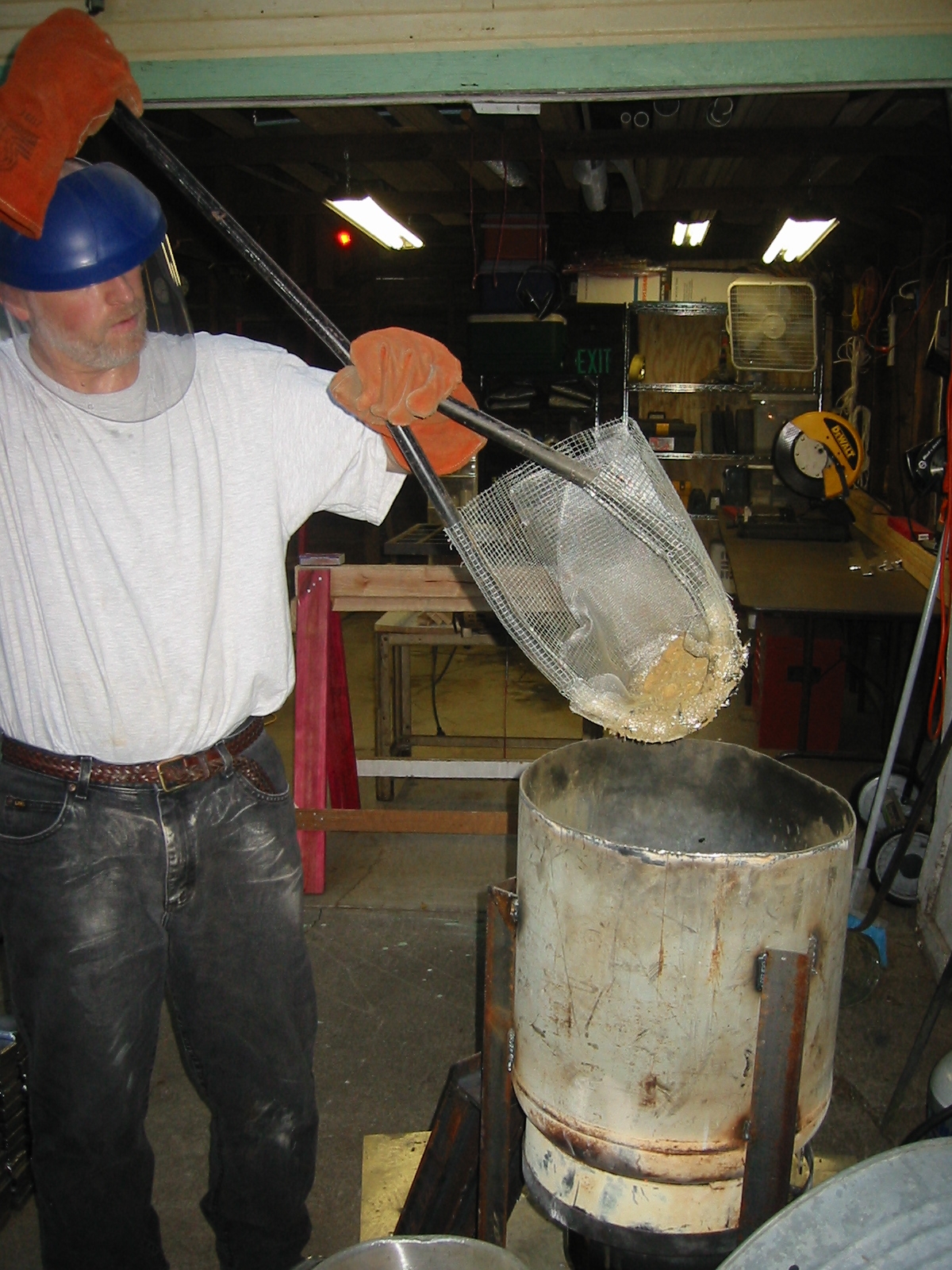 Screening the remaining trash from the molten lead.