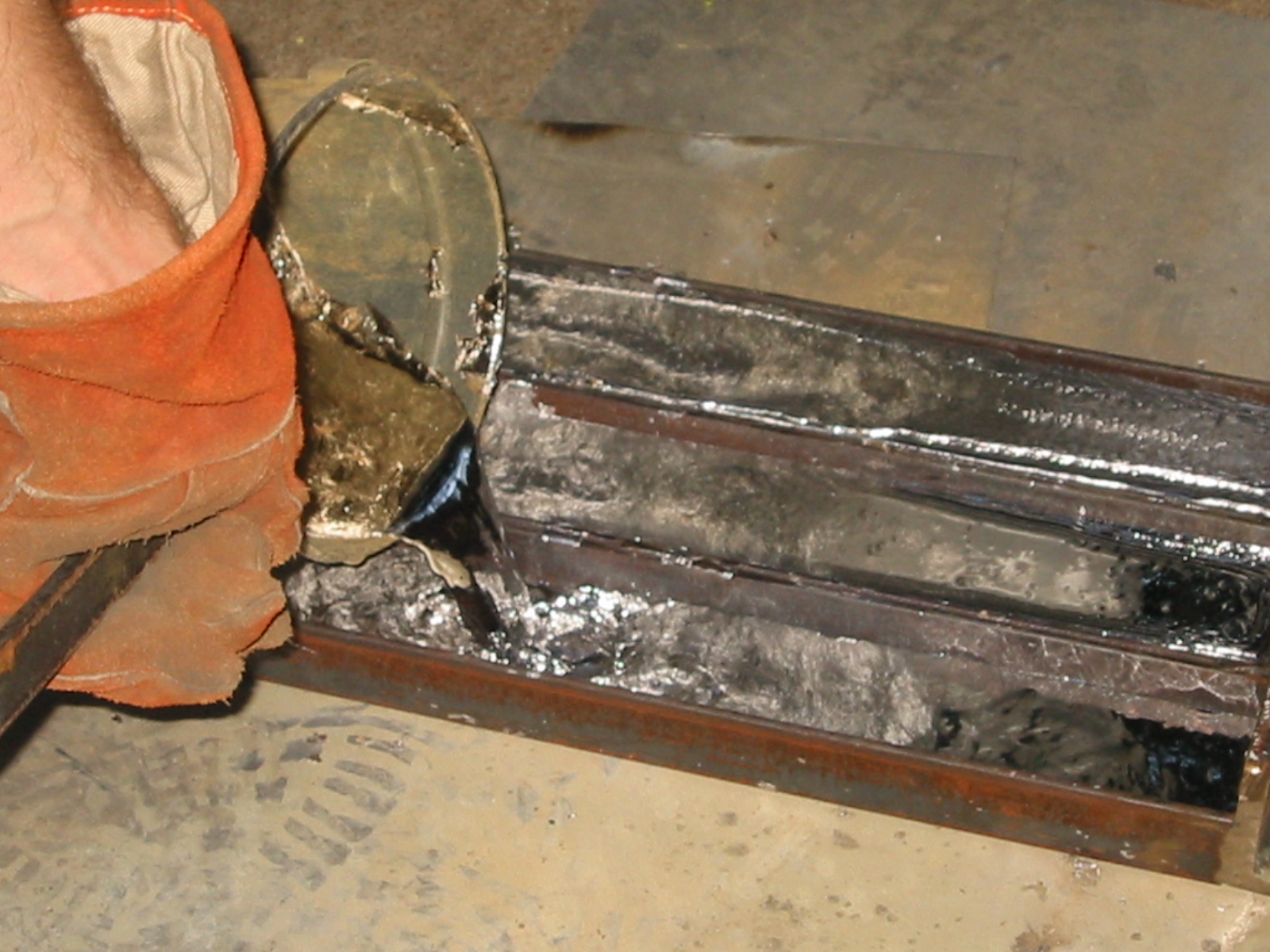 Casting lead ingots.