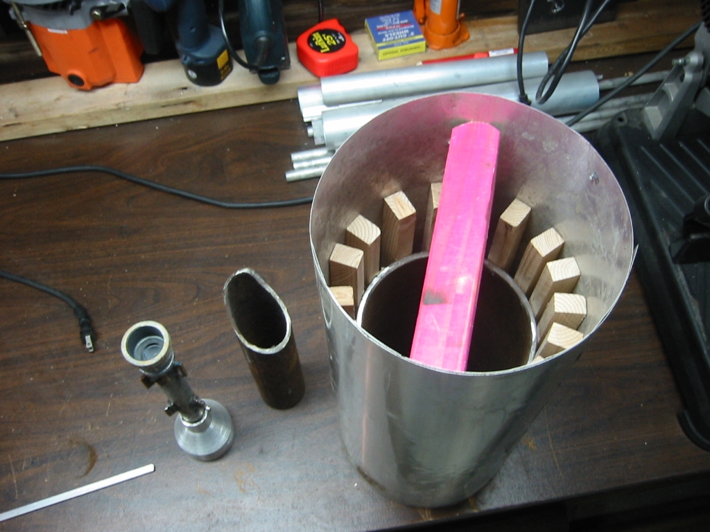(5) Inside form made by  wrapping flashing around wood furring strips that are glued to the  steel crucible.