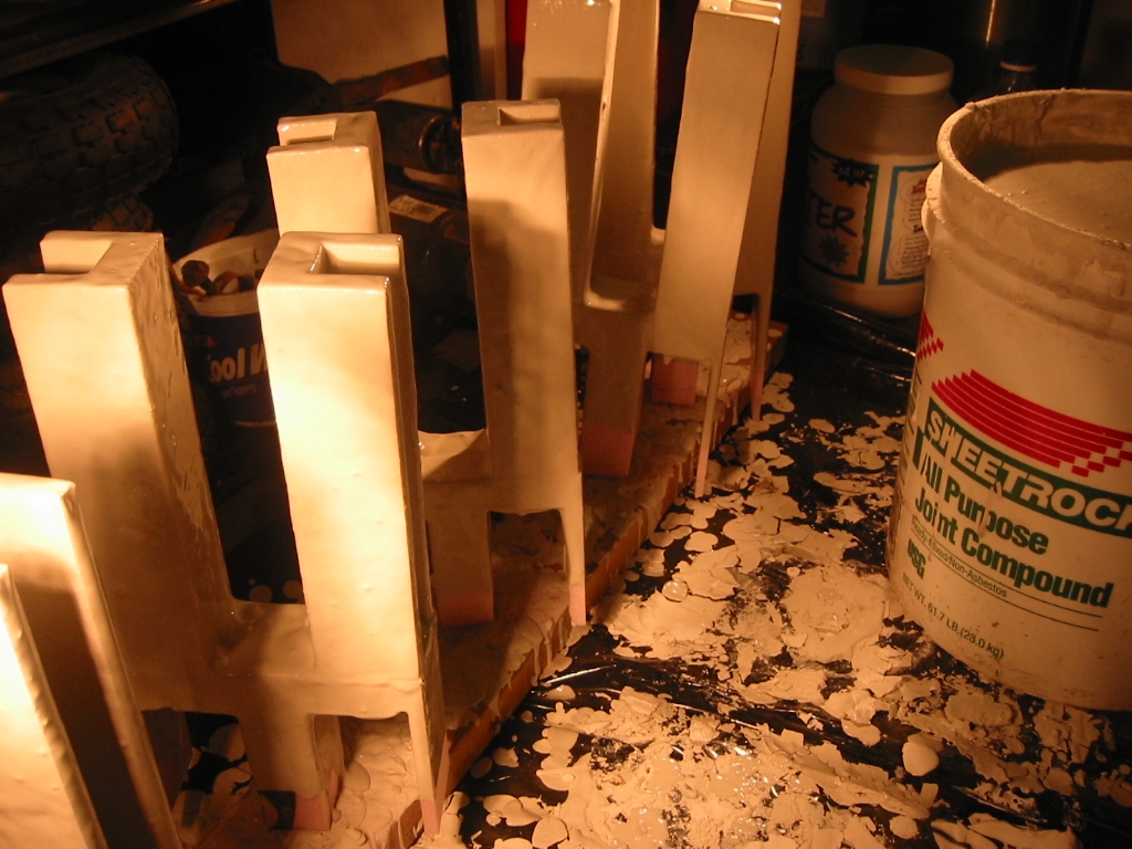 (2) Sheetrock mud coated parts drying in front of a heat lamp.  Others are drying in an oven at 175 degrees F.