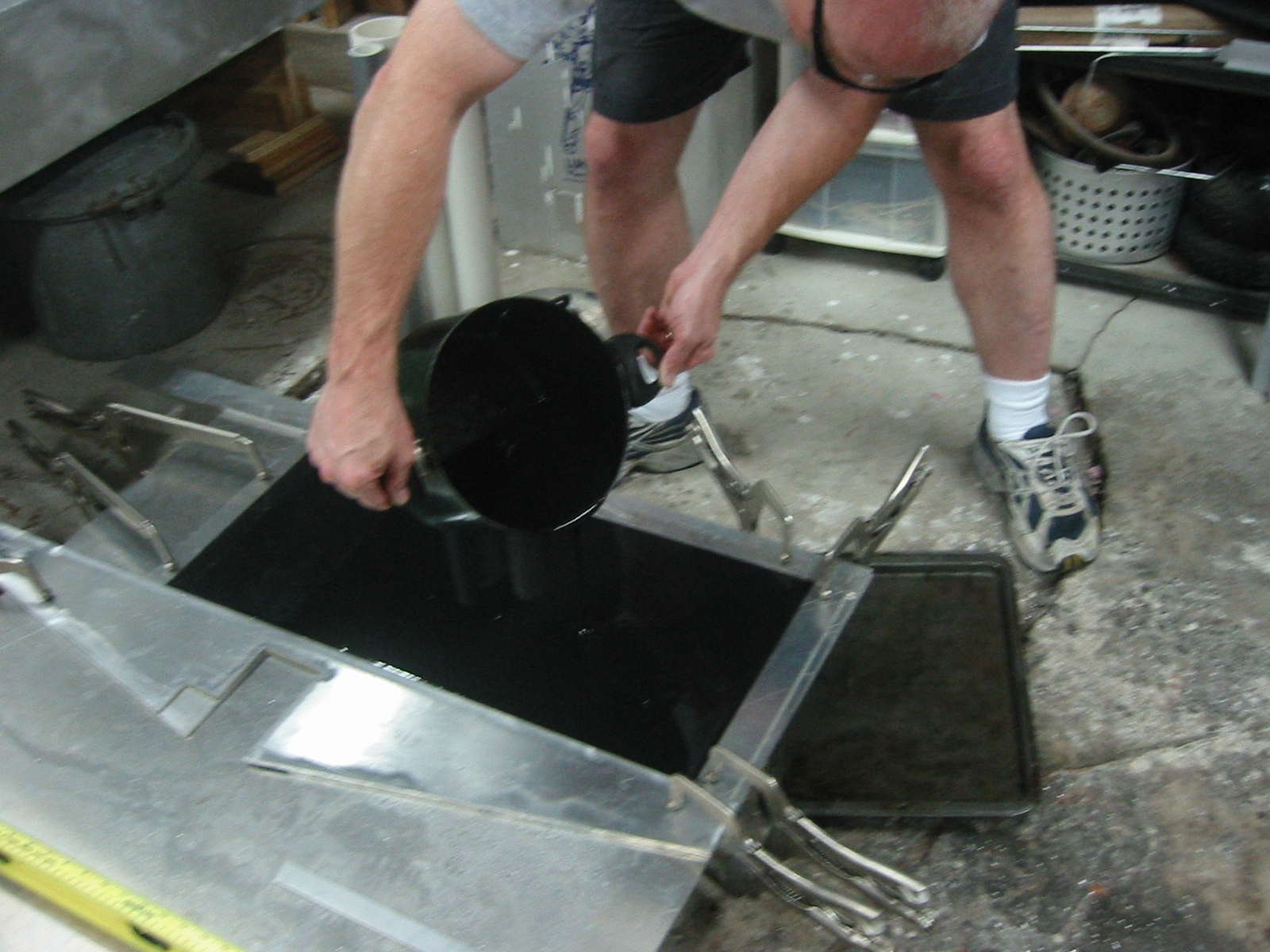 (2) Machineable wax being poured into the mold.