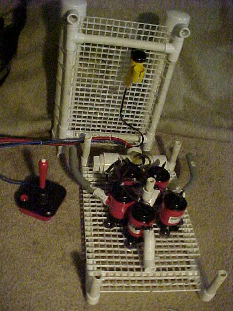 BOB with the top open showing bilge pumps, camera, and electric relay switch housing.